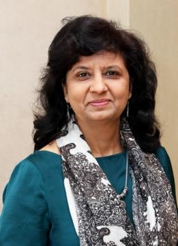 portrait of Suman Sachdeva in a green top with a white and black scarf